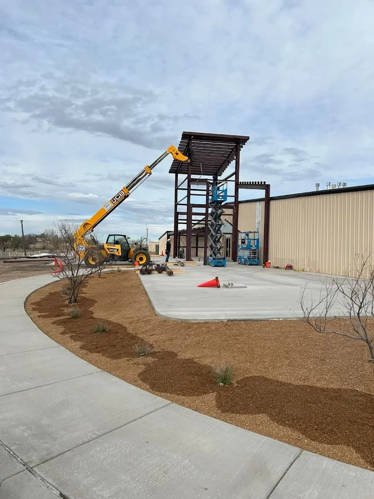 Commercial building under construction with a lift and stair tower