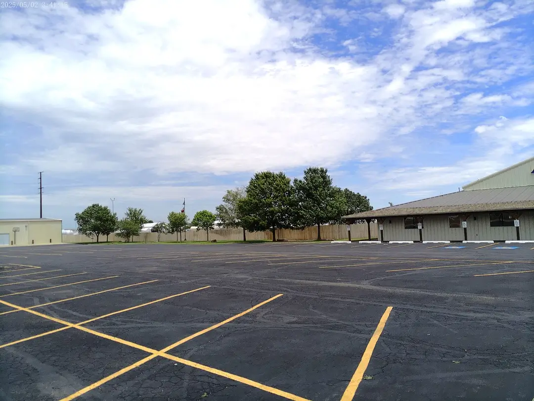 Side of the Arena of Life Church building across the parking lot