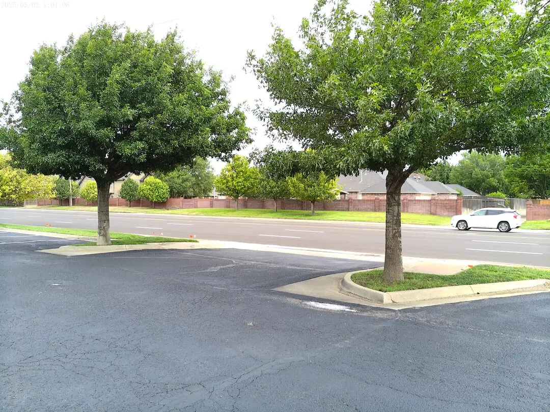 Landscaped parking island with shade trees at Church of Christ of the Colonies