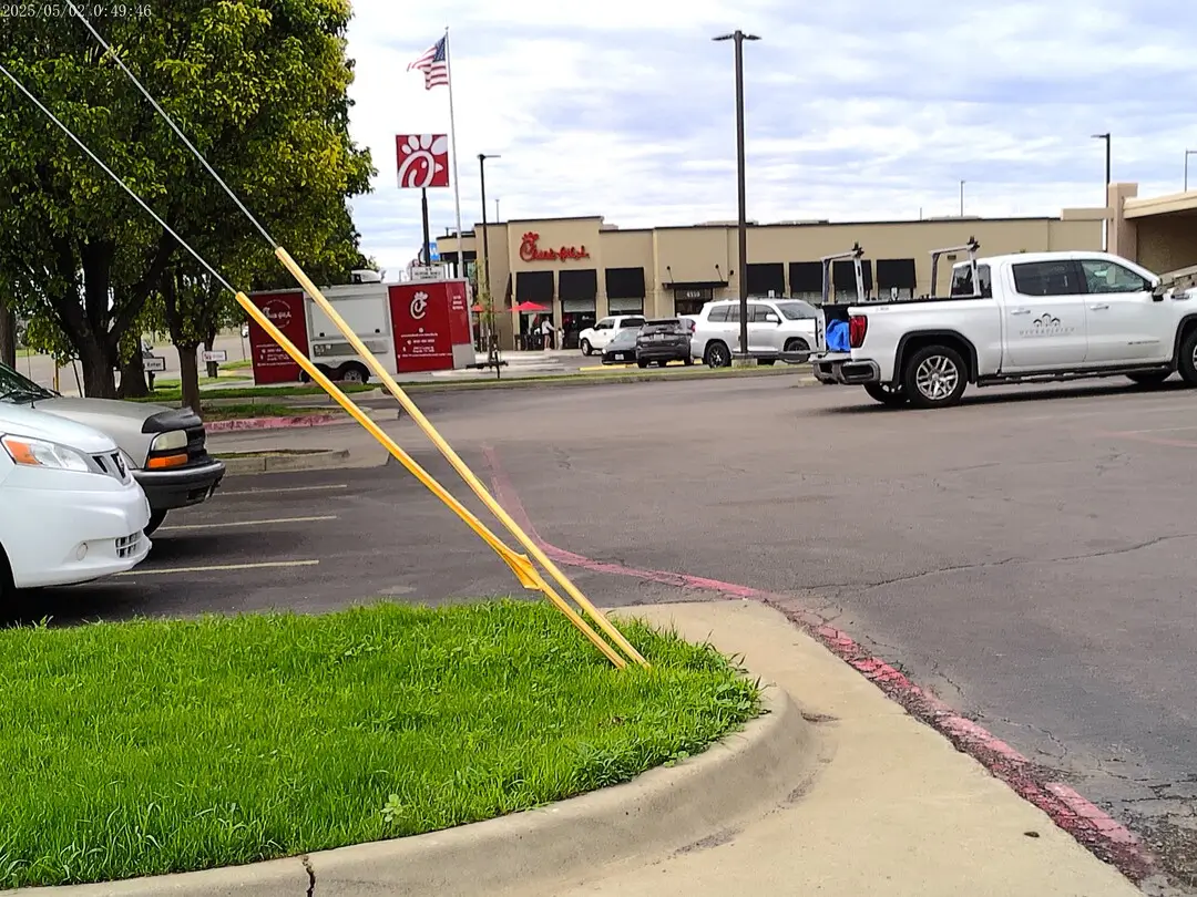 Curbed landscaping and parking at Party Stop on Coulter Street