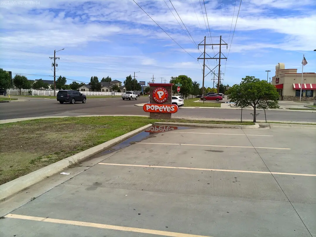 Popeyes sign at the street entrance on Coulter Street