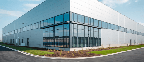 Modern office warehouse with a glass corner entry and metal panel walls